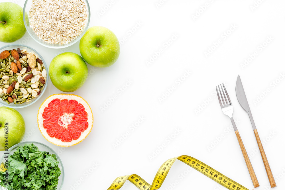 Weight loss concept with green organic food on white background top view space for text